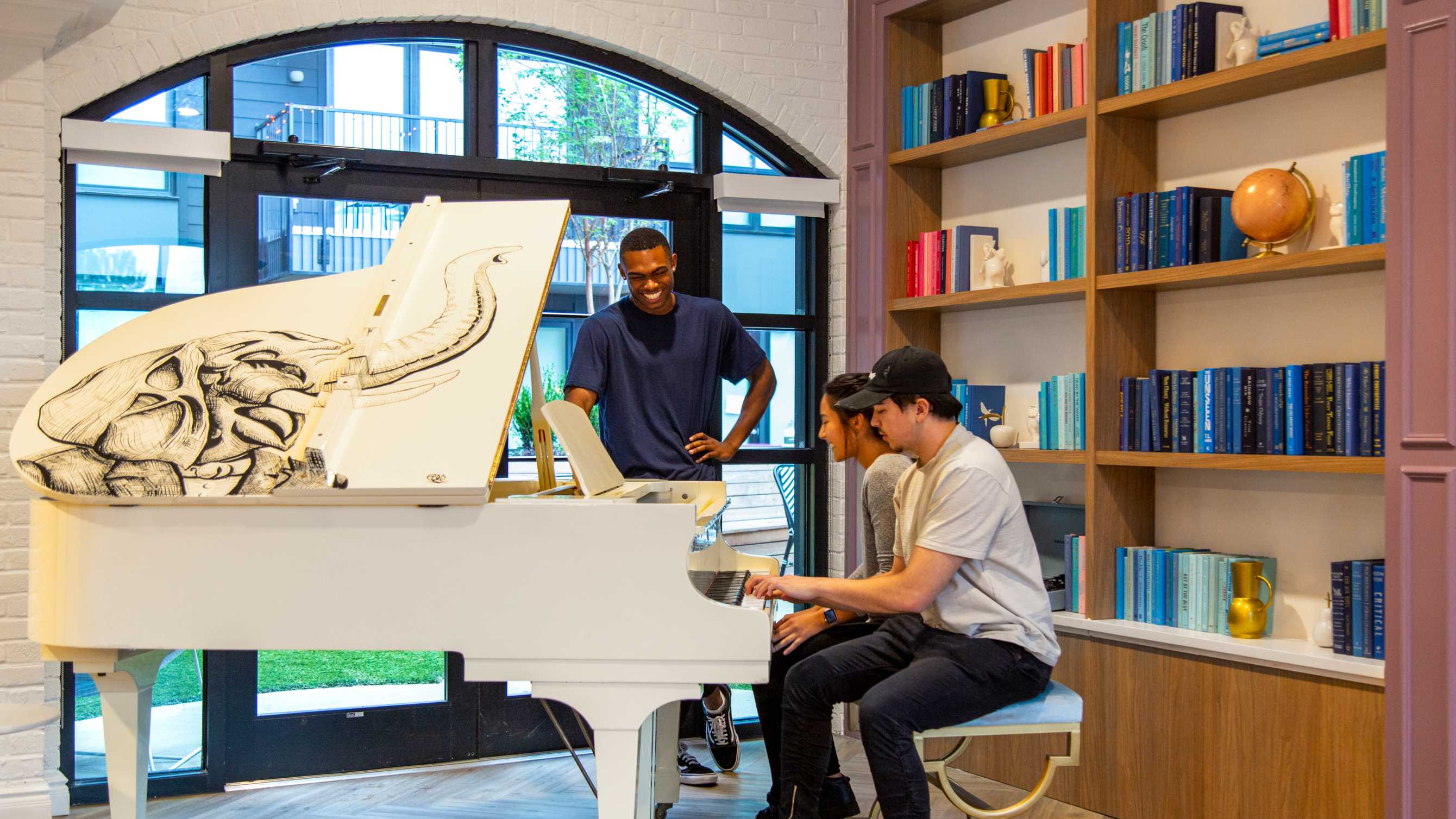 A group of people playing the piano