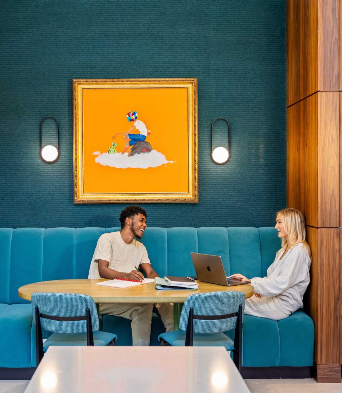 Two friends sitting on blue chairs