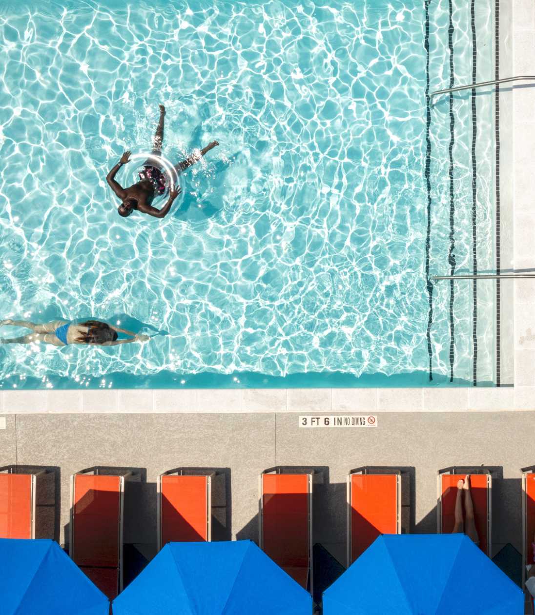 Two people swimming in a pool