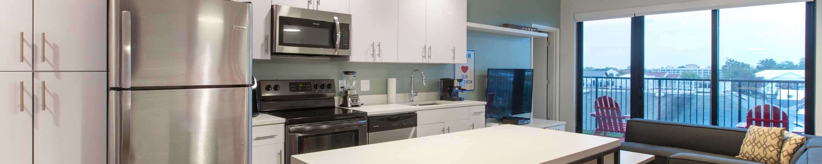 A kitchen with white cabinets