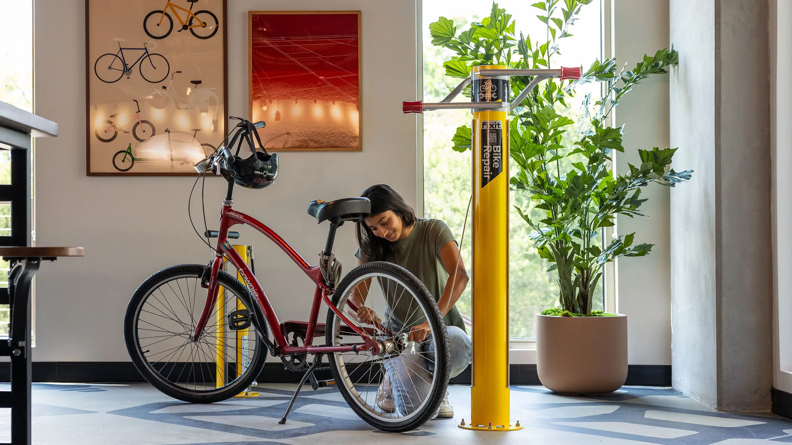 young woman fixing a bike