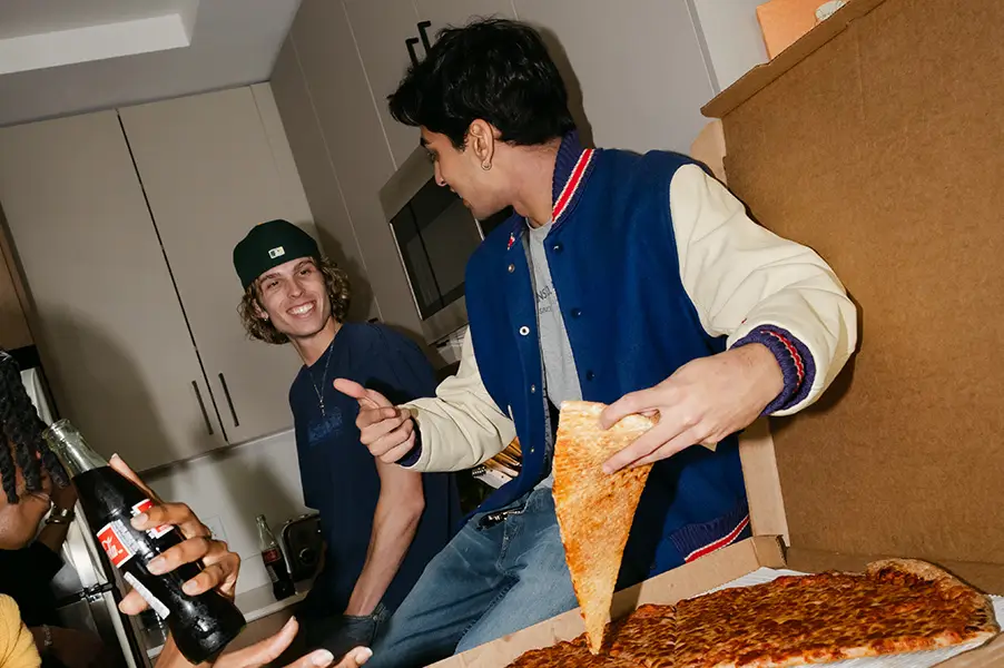 Young men eating pizza