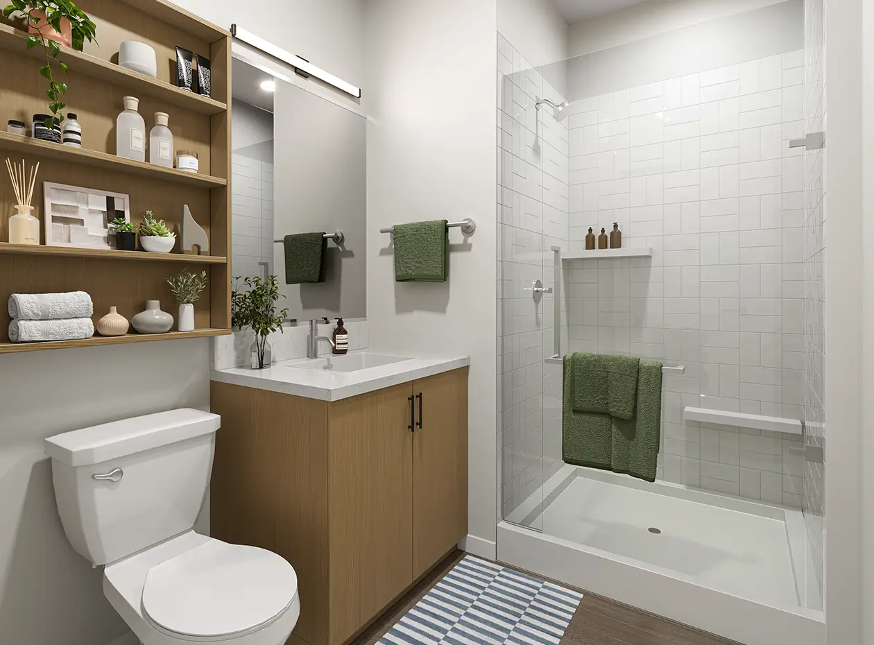 Toilet, shower, and sink with cabinets.