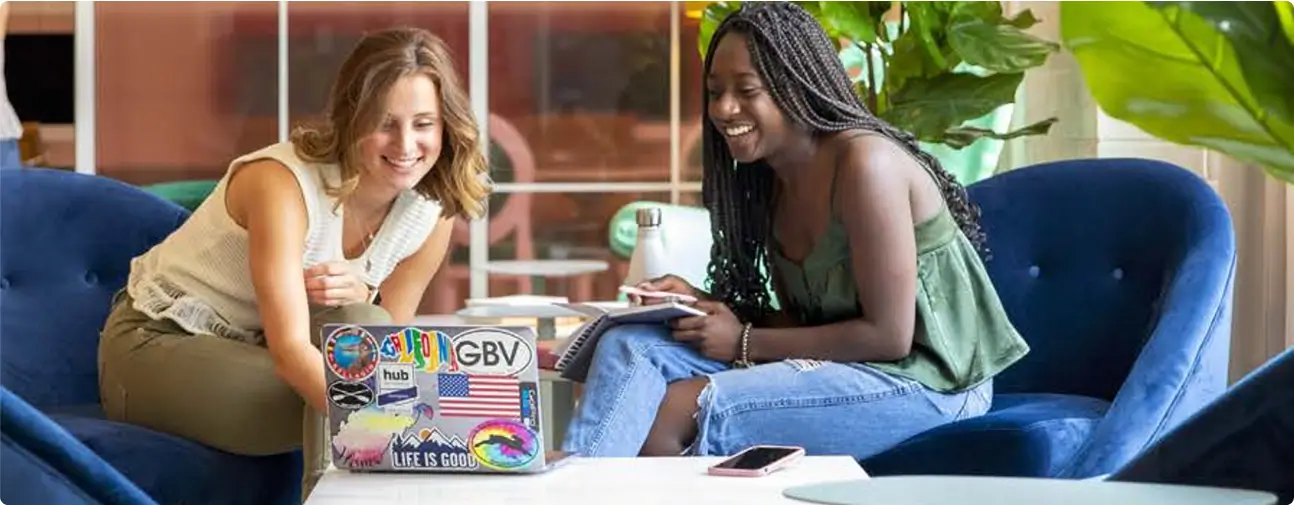 two people working on a laptop