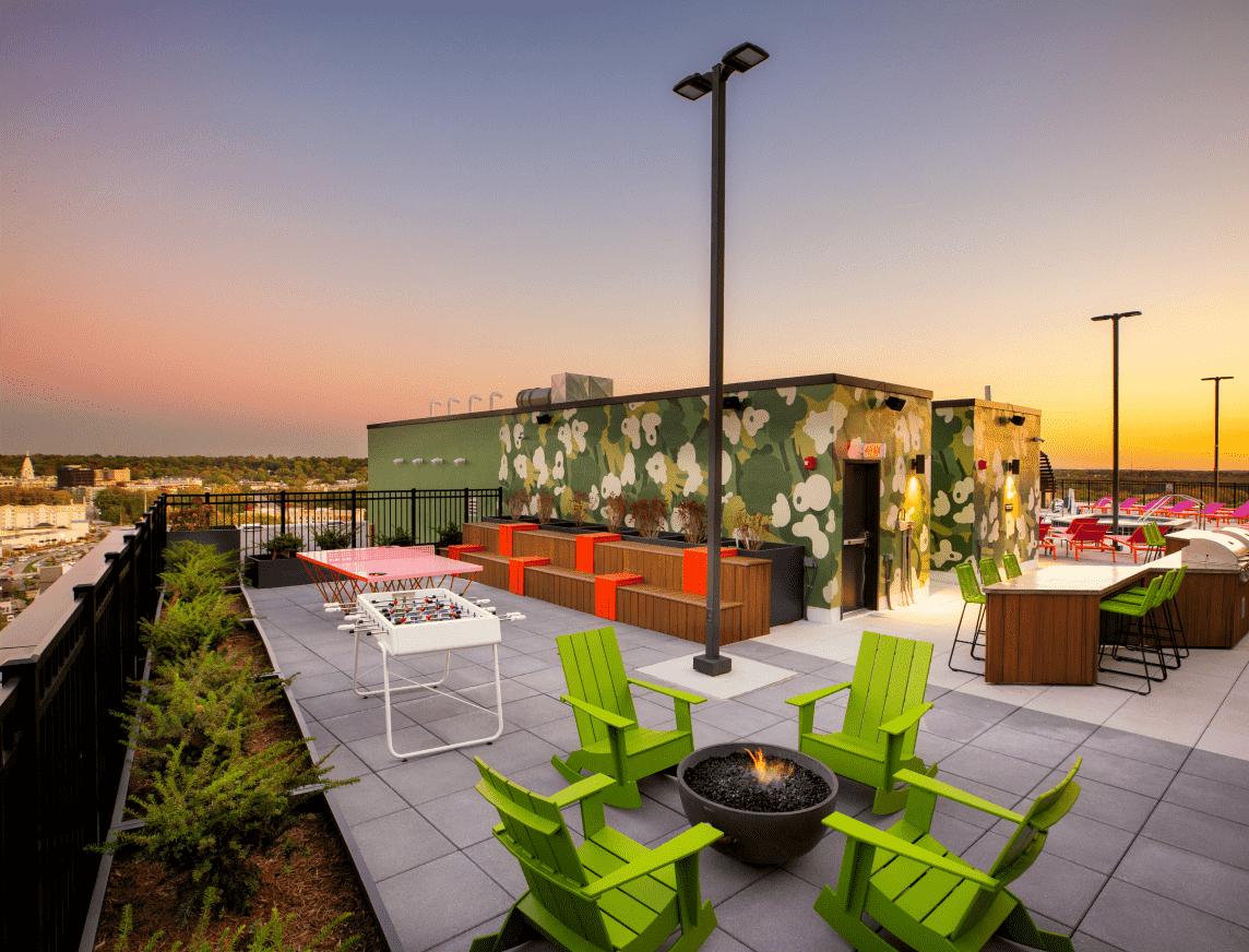 Bright green chairs around an outdoor firepit