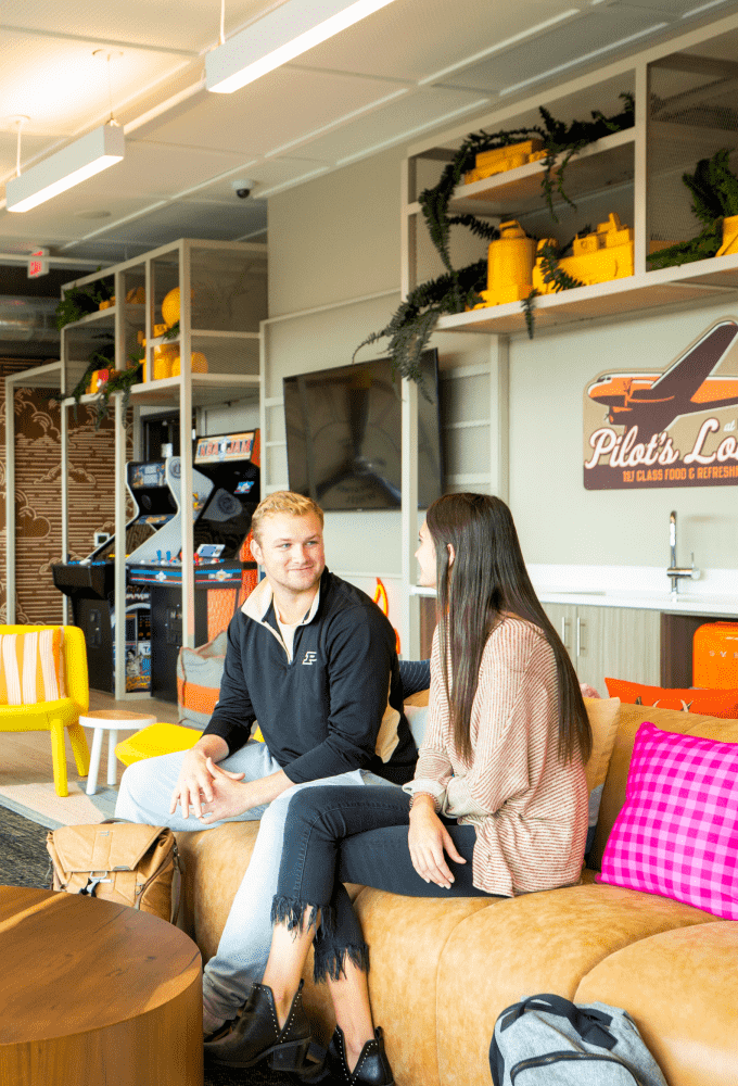 Two people talking together on a couch