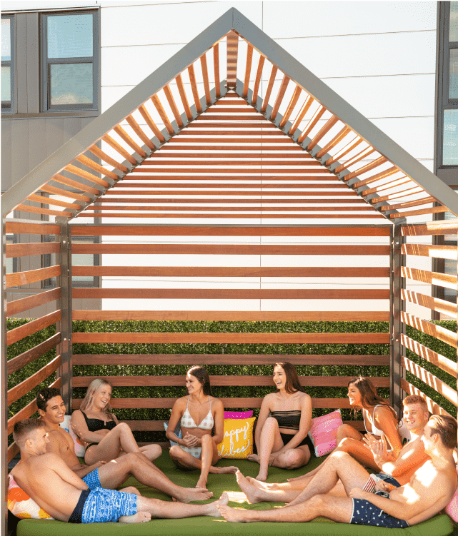 Group of friends outside under a wooden structure